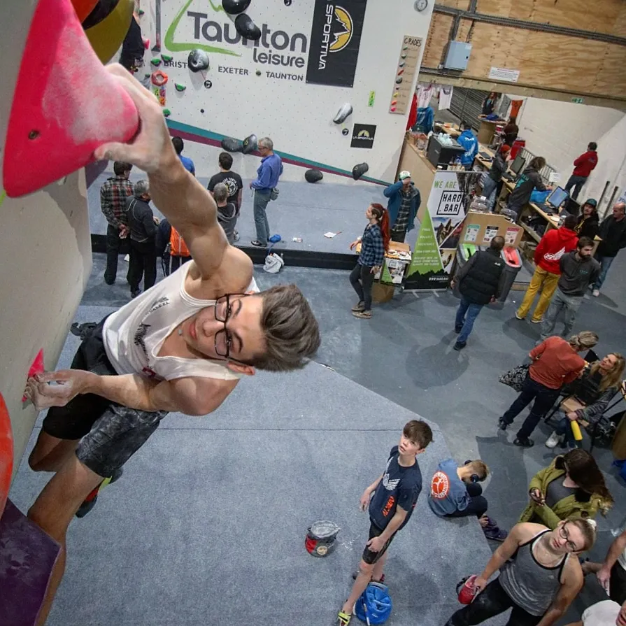Climber ascending a bouldering wall